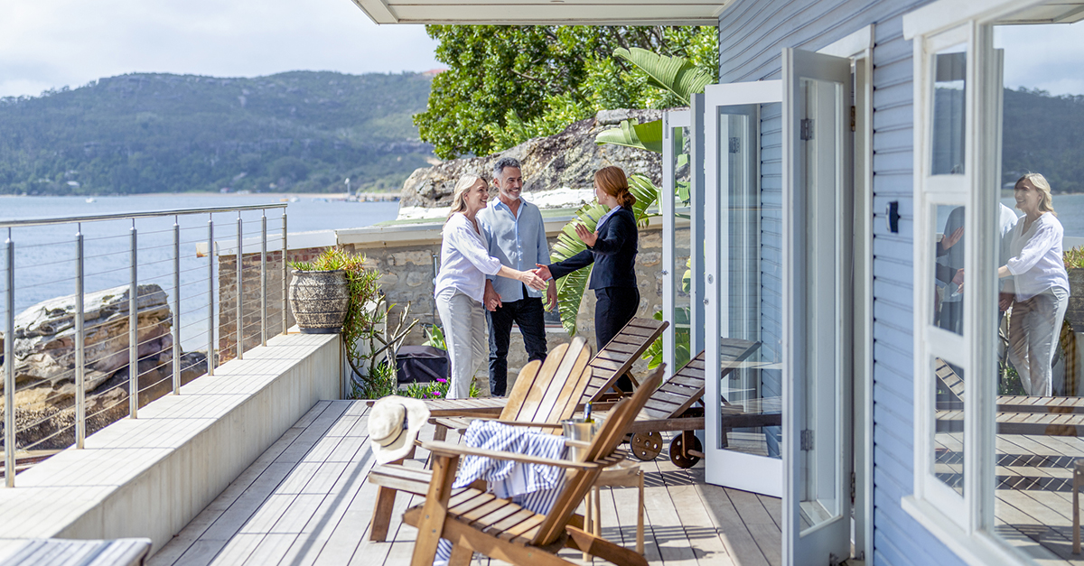A couple meeting with an agent, purchasing investment property.