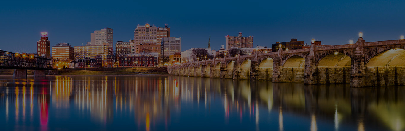 Guardian Transfer hero image Bridge and lighted city at dusk