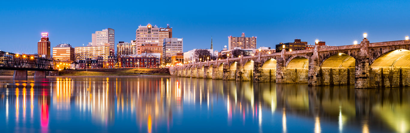 Bridge and lighted city at dusk