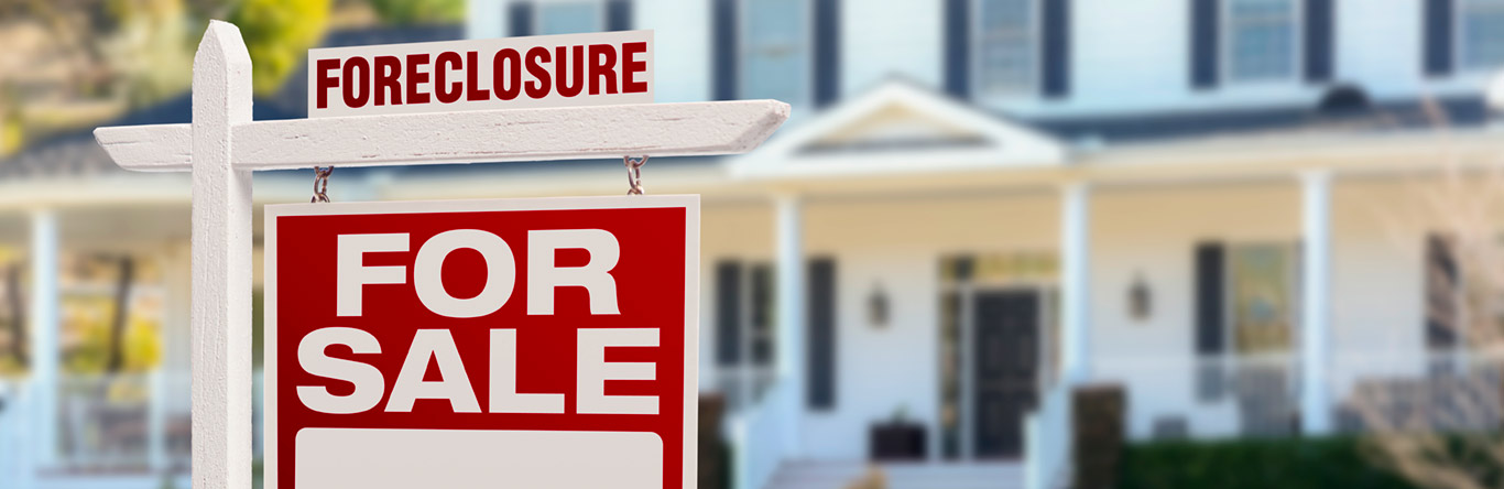 Foreclosure for sale sign in front of home