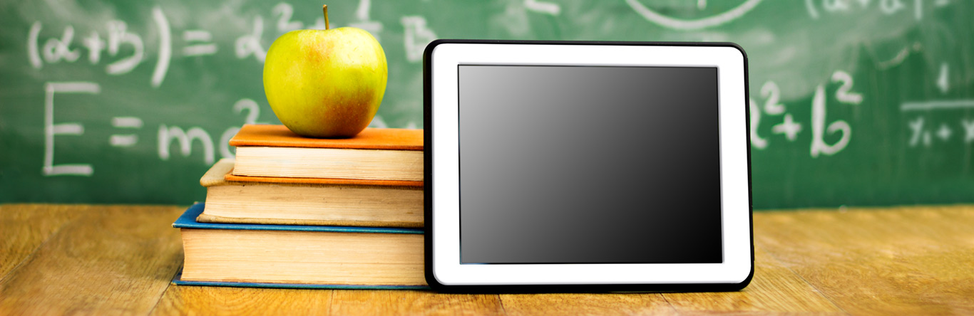 education image green apple on 3 books next to tablet